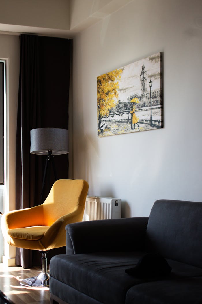 Crafting Captivating Headlines: Your awesome post title goes here Modern living room featuring a yellow armchair, wall art, and soft lighting.